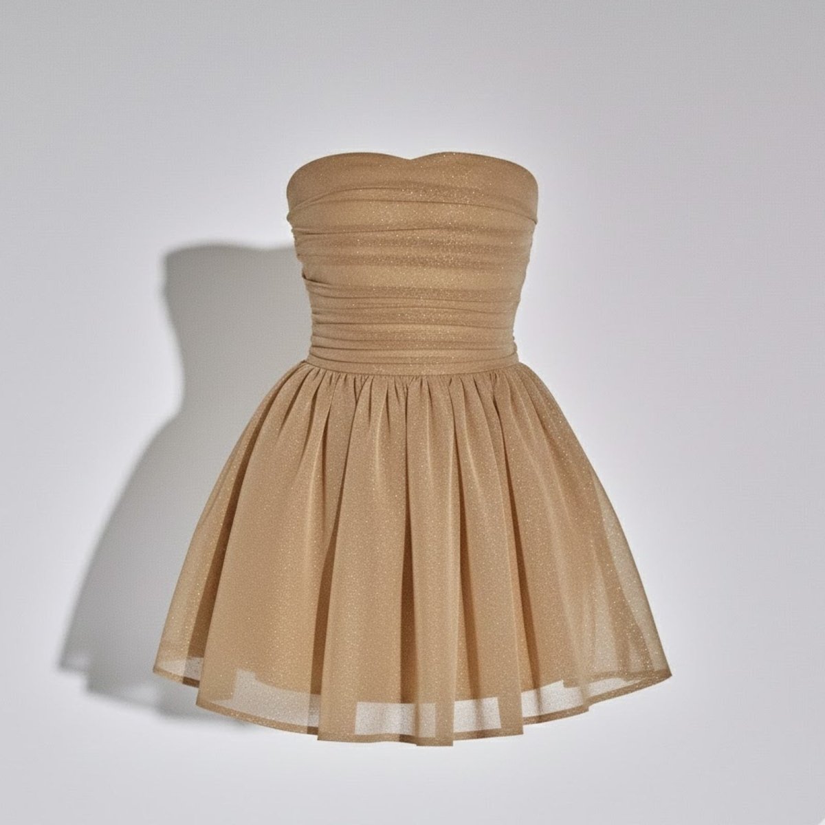 Product-only photo of the light tan strapless mini dress by Kouvr Fashion, showing the sweetheart neckline and ruched bodice detail from the front.