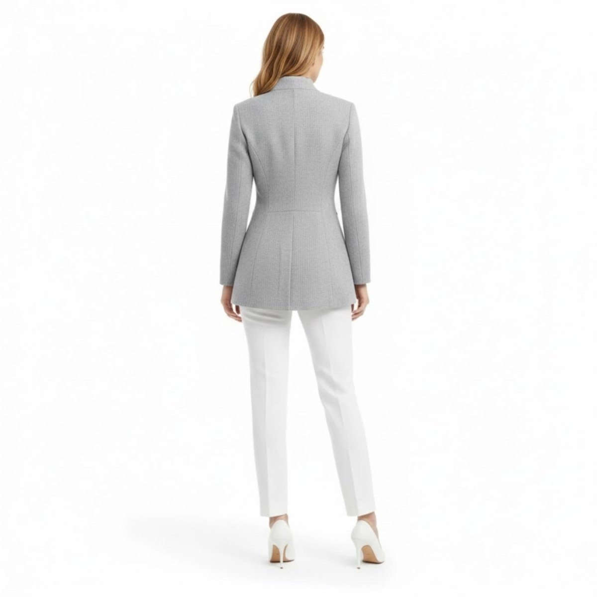 Back view of the Kouvr Fashion light gray herringbone blazer on a model, highlighting the tailored waist and seam details.