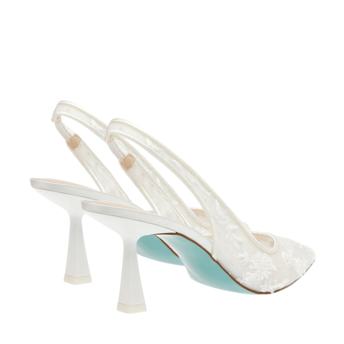 White Kouvr high-heeled shoes with blue soles on a white background