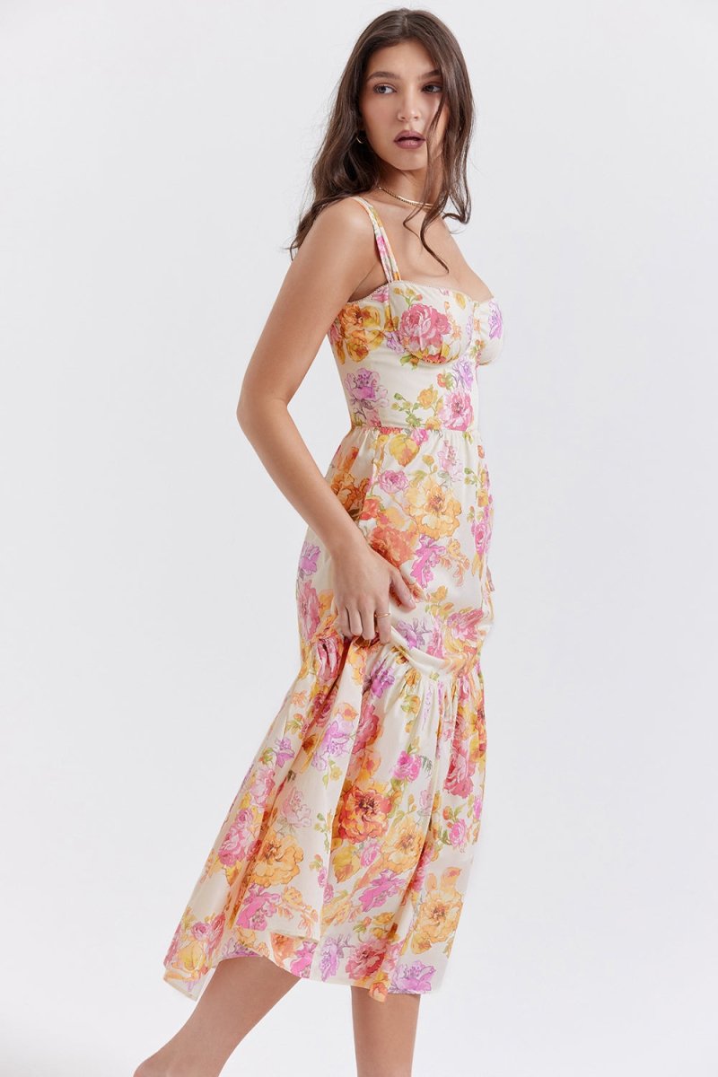 Side profile of a woman in The Persephone floral bustier midi dress, highlighting the A-line silhouette and tiered hem.03