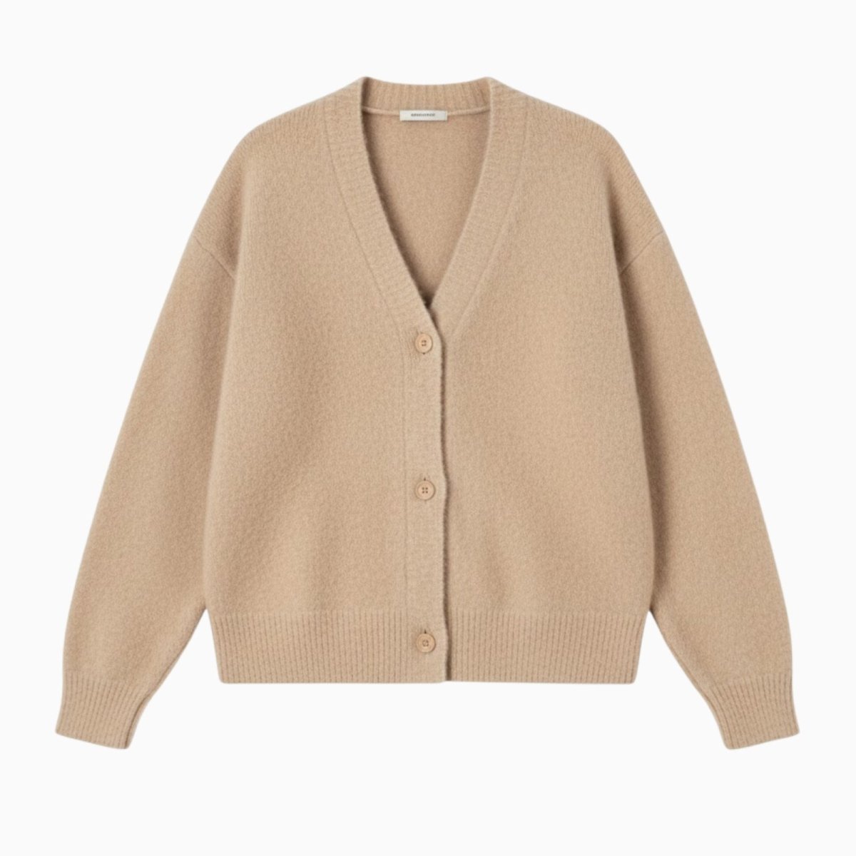 Flat lay of a beige V-neck cashmere cardigan with horn buttons, showing the texture of the luxury knit