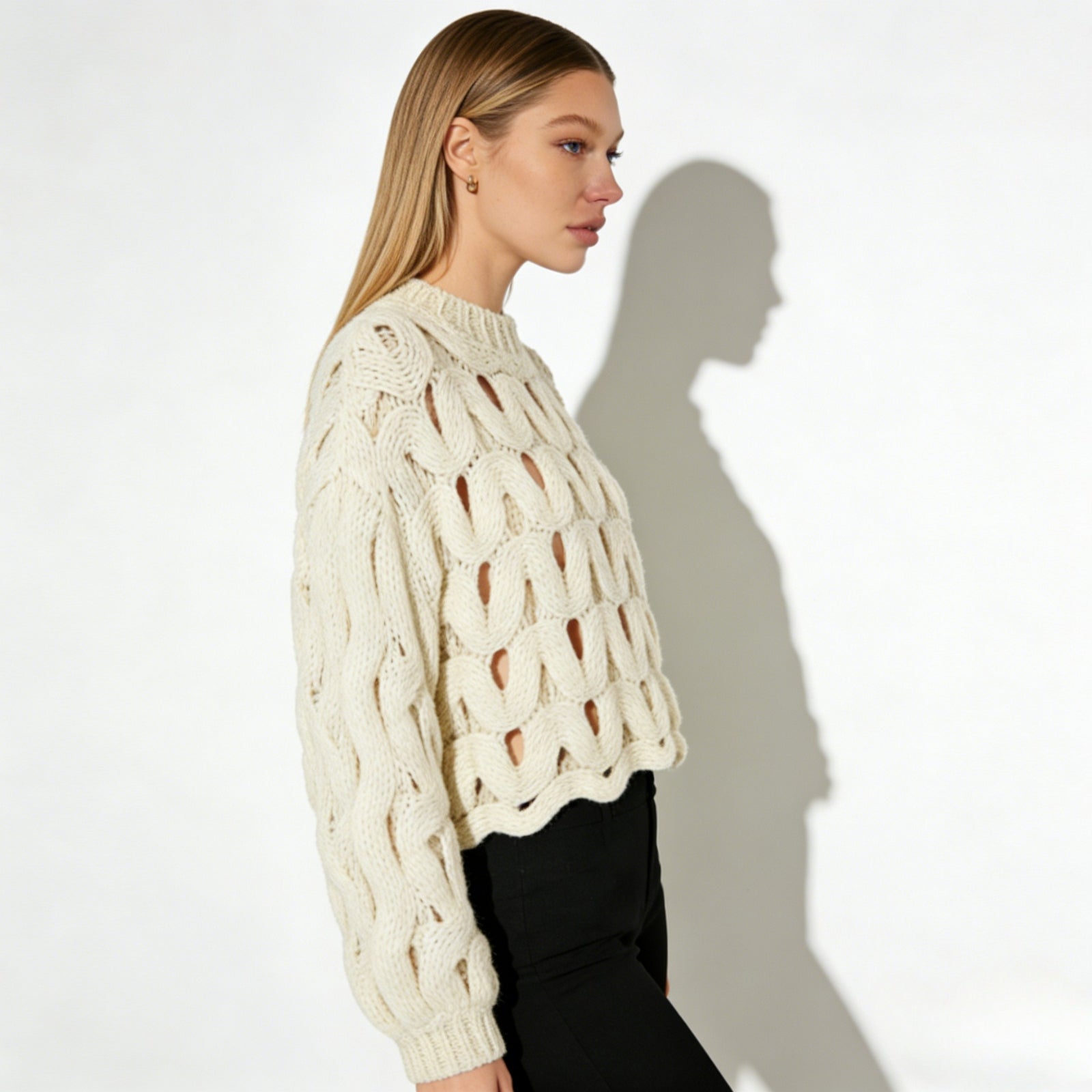 Side view of a model in the Kouvr Fashion Vanice sweater, highlighting the balloon sleeve silhouette and cropped length.