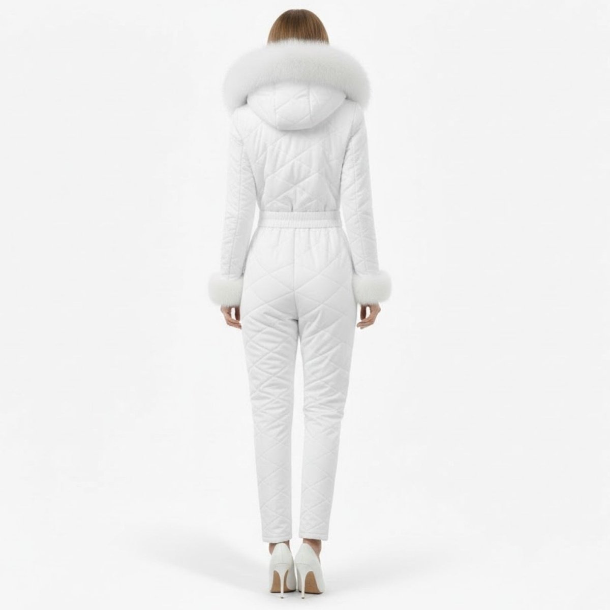 Back view of a woman in a fitted white hooded snowsuit showing the quilted detailing and slim silhouette.