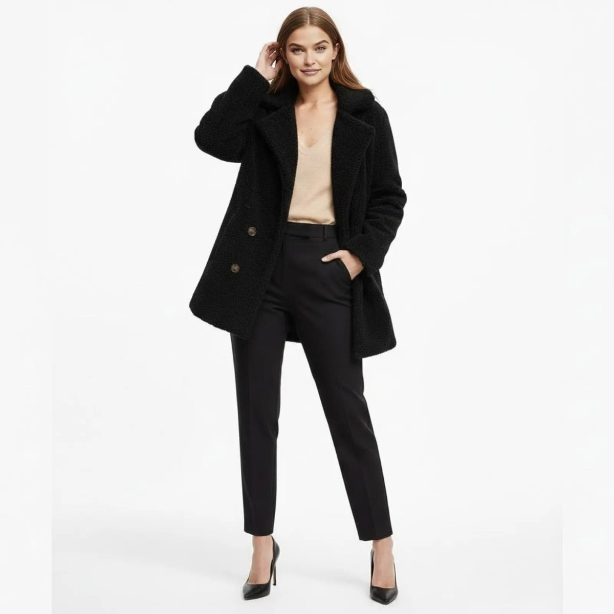Model wearing the Kouvr Fashion black double-breasted teddy coat styled with black trousers and a cream silk camisole.