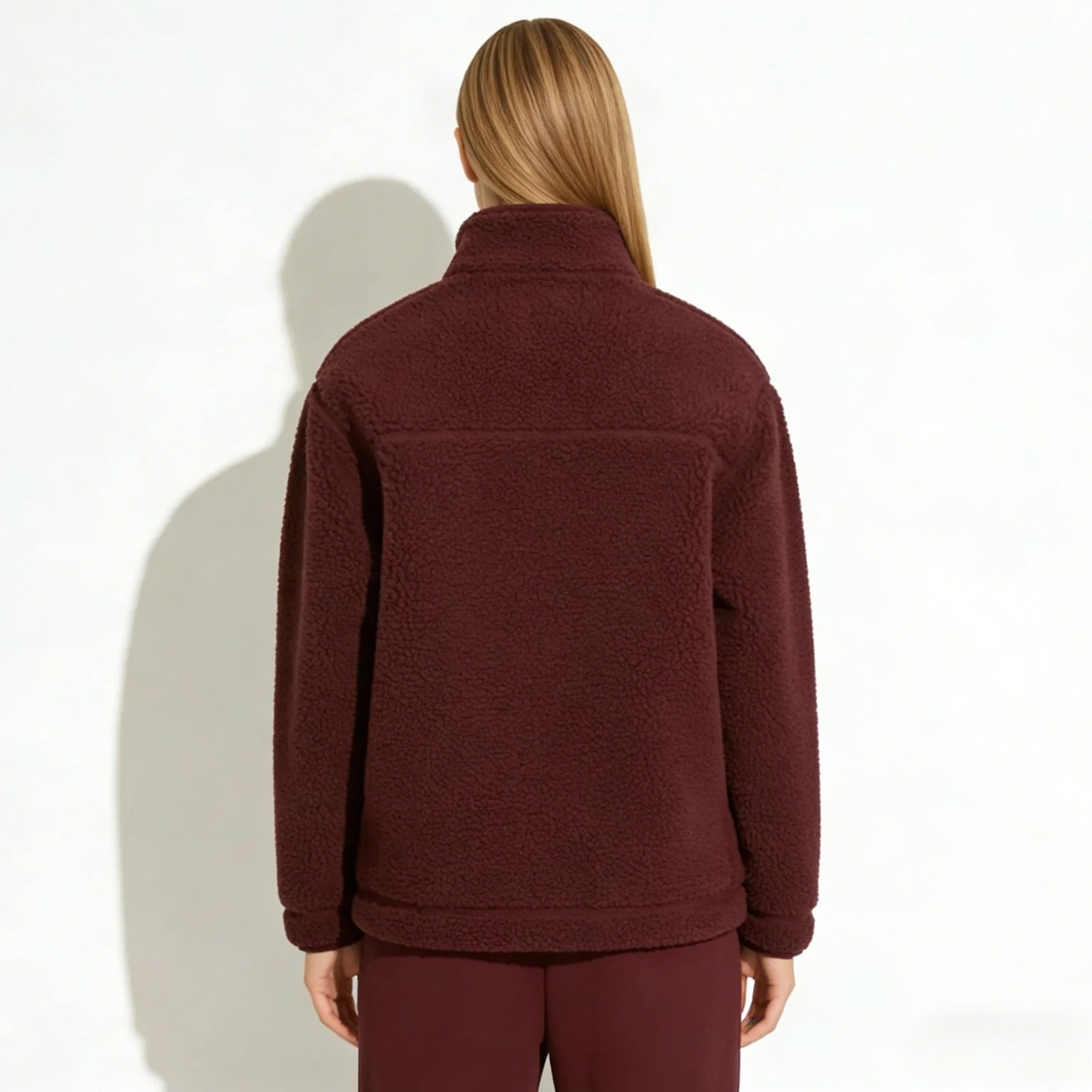 Back view of the Kouvr Fashion women's burgundy sherpa fleece jacket highlighting the yoke detail and relaxed silhouette.