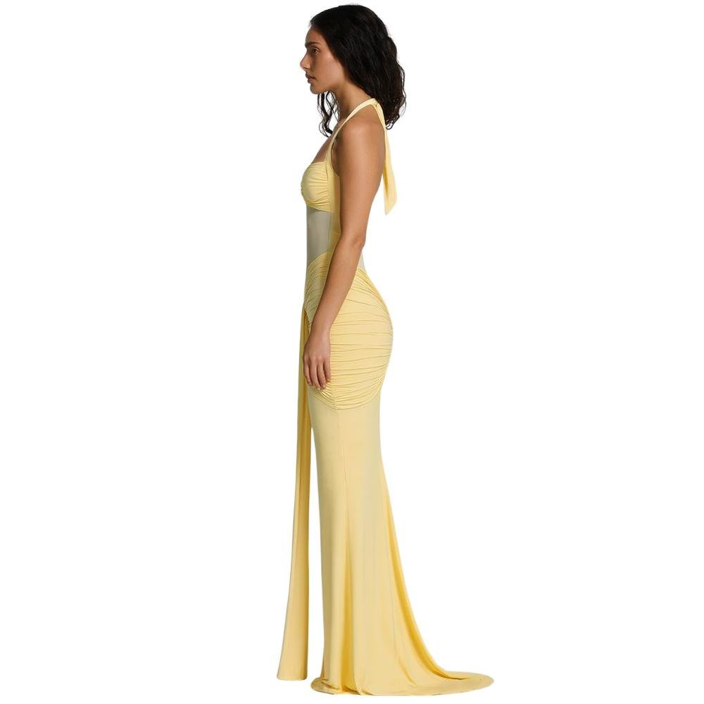 Woman wearing a yellow kouvr evening gown on a white background