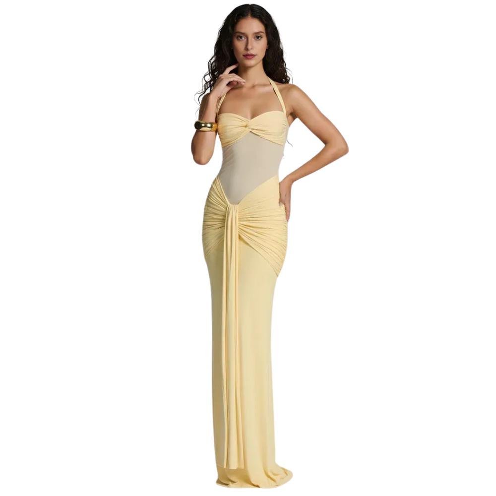 Woman wearing a yellow kouvr evening gown on a white background