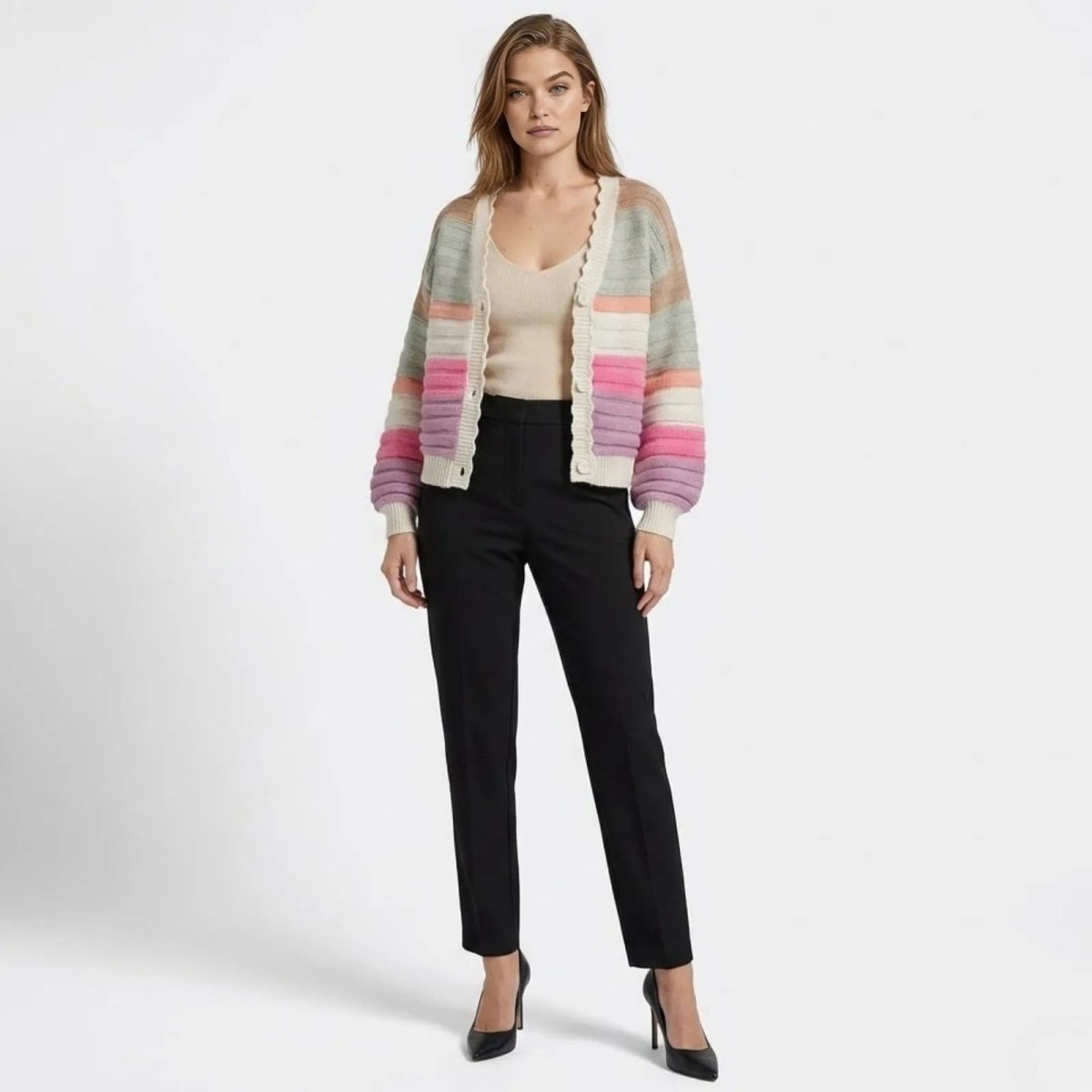 Model wearing the Kouvr Fern multicolor striped balloon sleeve cardigan with black trousers, shown from the front.