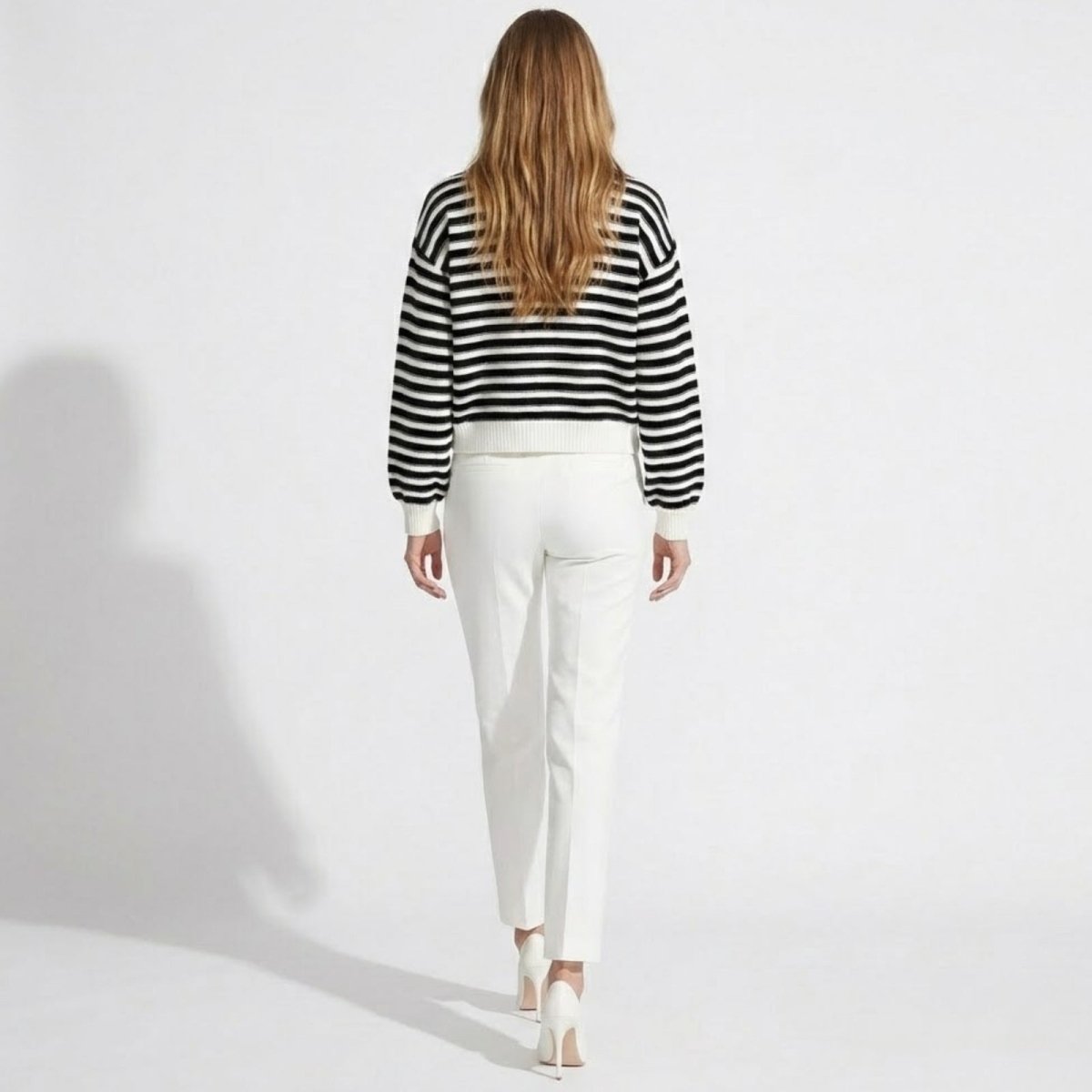 Back view of the Kouvr black and white horizontal striped cardigan, displaying the full pattern and ribbed hem.