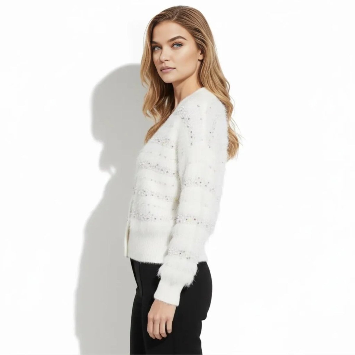 Side profile of model in the Kouvr white eyelash knit cardigan showing sleeve texture and relaxed fit.