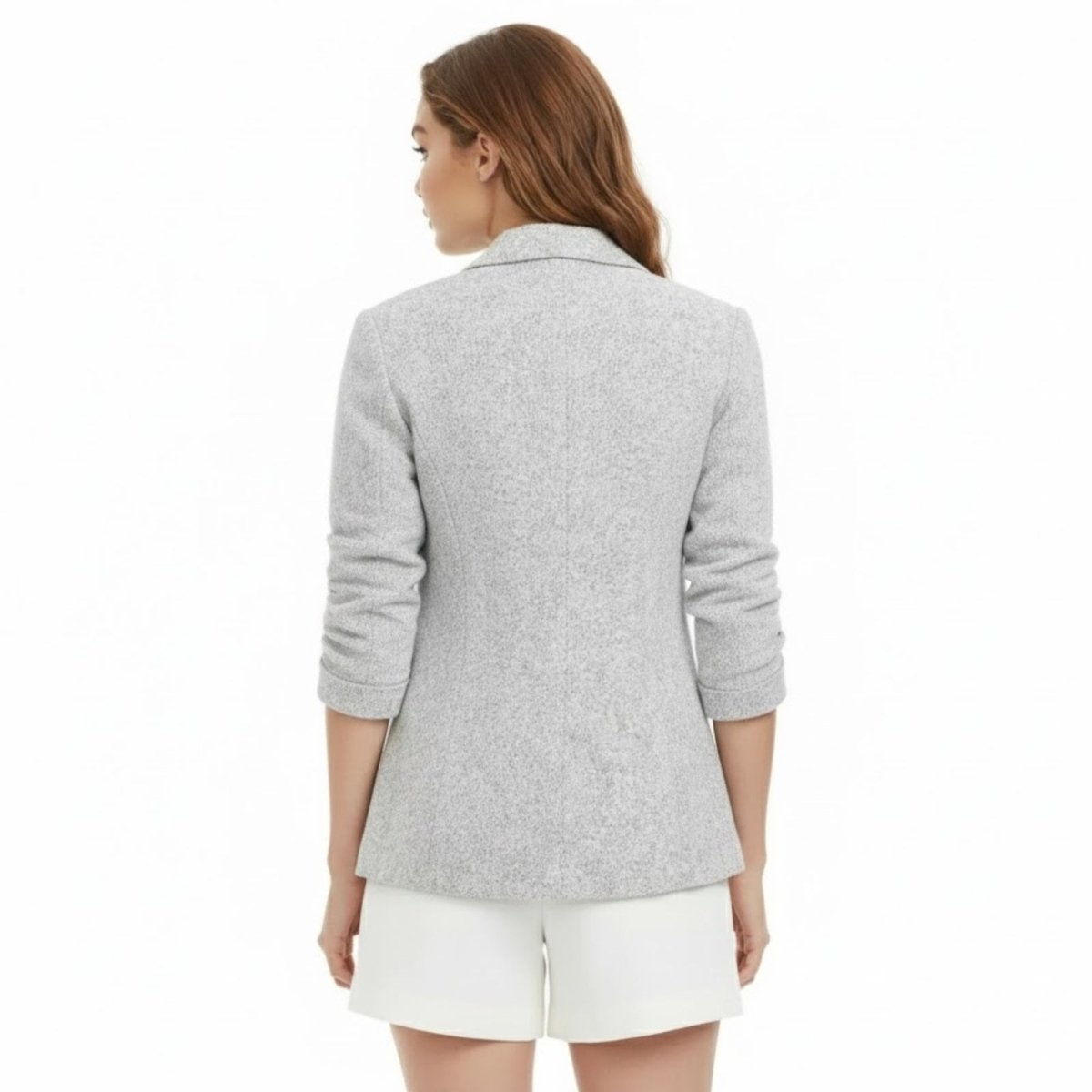 Back view of the Kouvr Geraldine Knit Blazer in light grey on a female model, highlighting the tailored seams and fit.