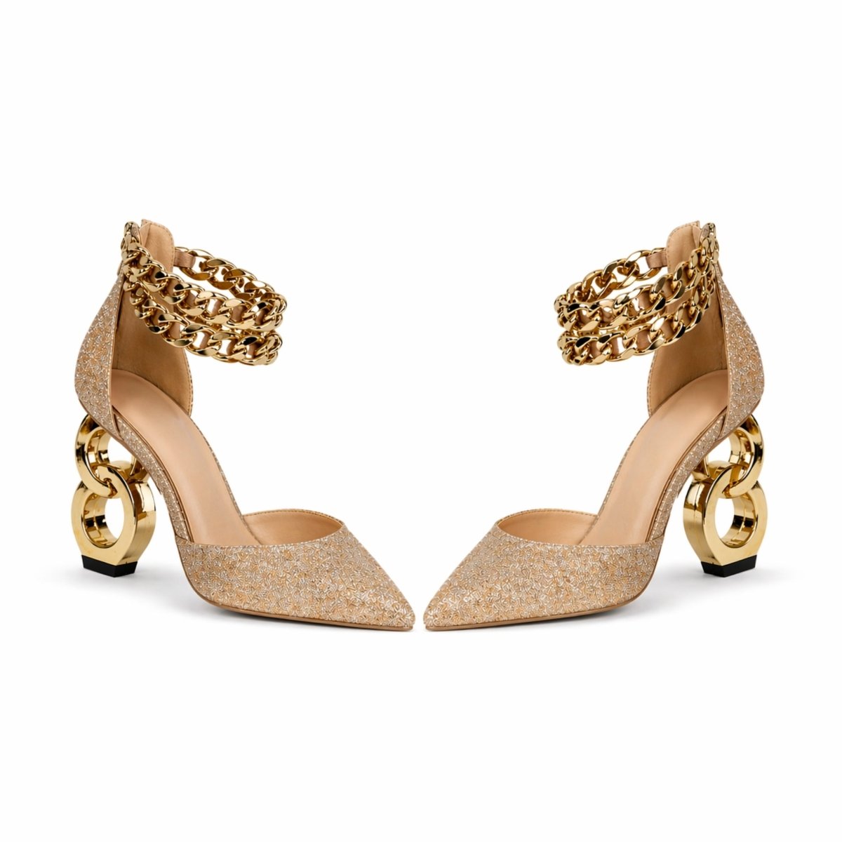 A pair of Kouvr gold glitter pointed-toe pumps with a sculptural chain link heel and double chain ankle straps on a white background.