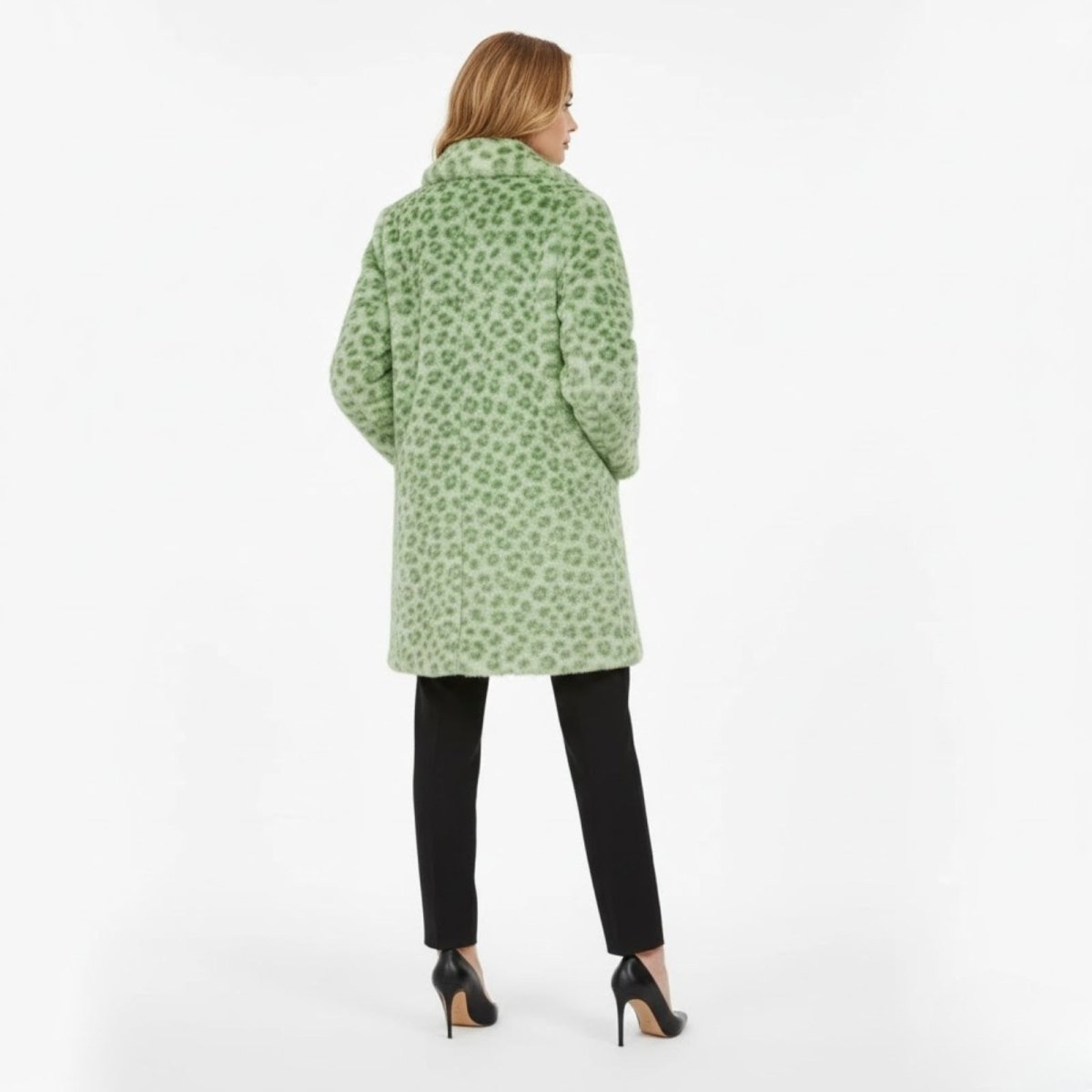 Model wearing the Kouvr green leopard print faux fur coat, shown from the back to highlight the all-over animal print pattern.