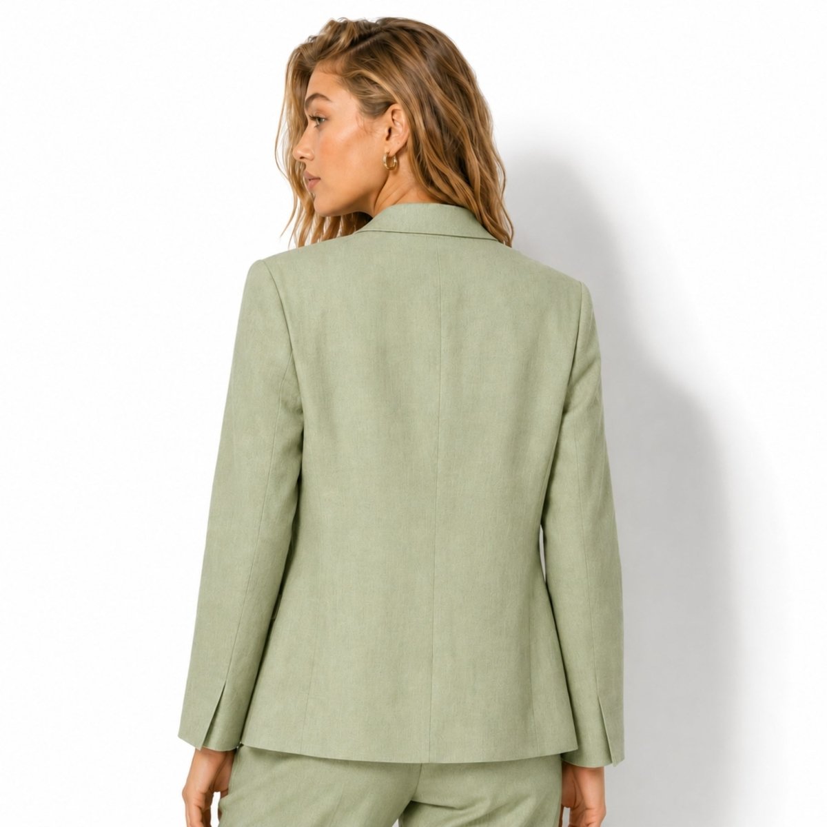 Back view of women's tailored light green linen suit jacket with center back vent