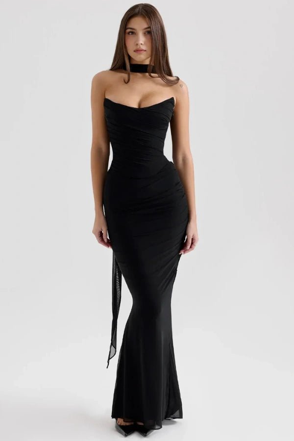 Model facing forward wearing the Kouvr Hailey black strapless mermaid gown, featuring a sweetheart neckline and ruched bodice.