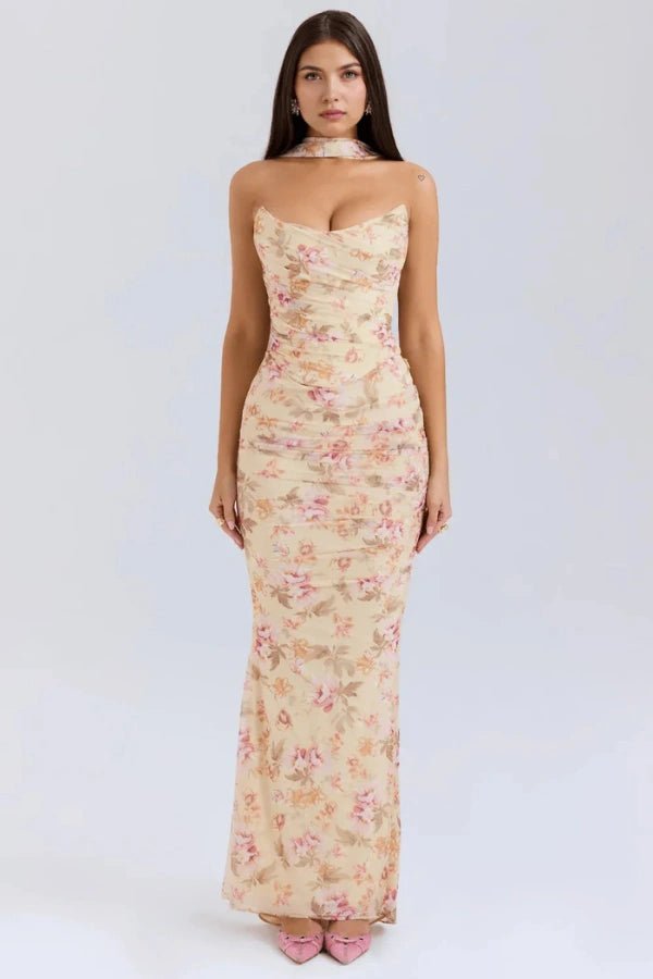 Model wearing Kouvr Hailey yellow floral strapless maxi dress with draped bodice and scarf detail, front view