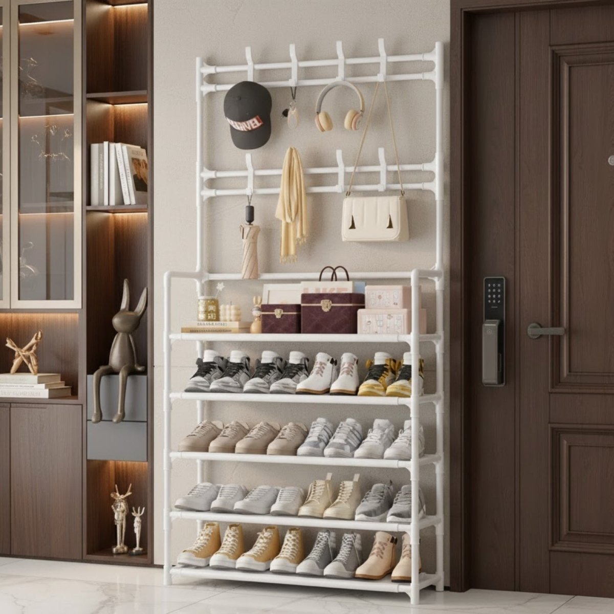 The Kouvr Architectural Hall Tree in matte black, styled in a modern entryway with coats and shoes, showcasing its 5-tier storage.