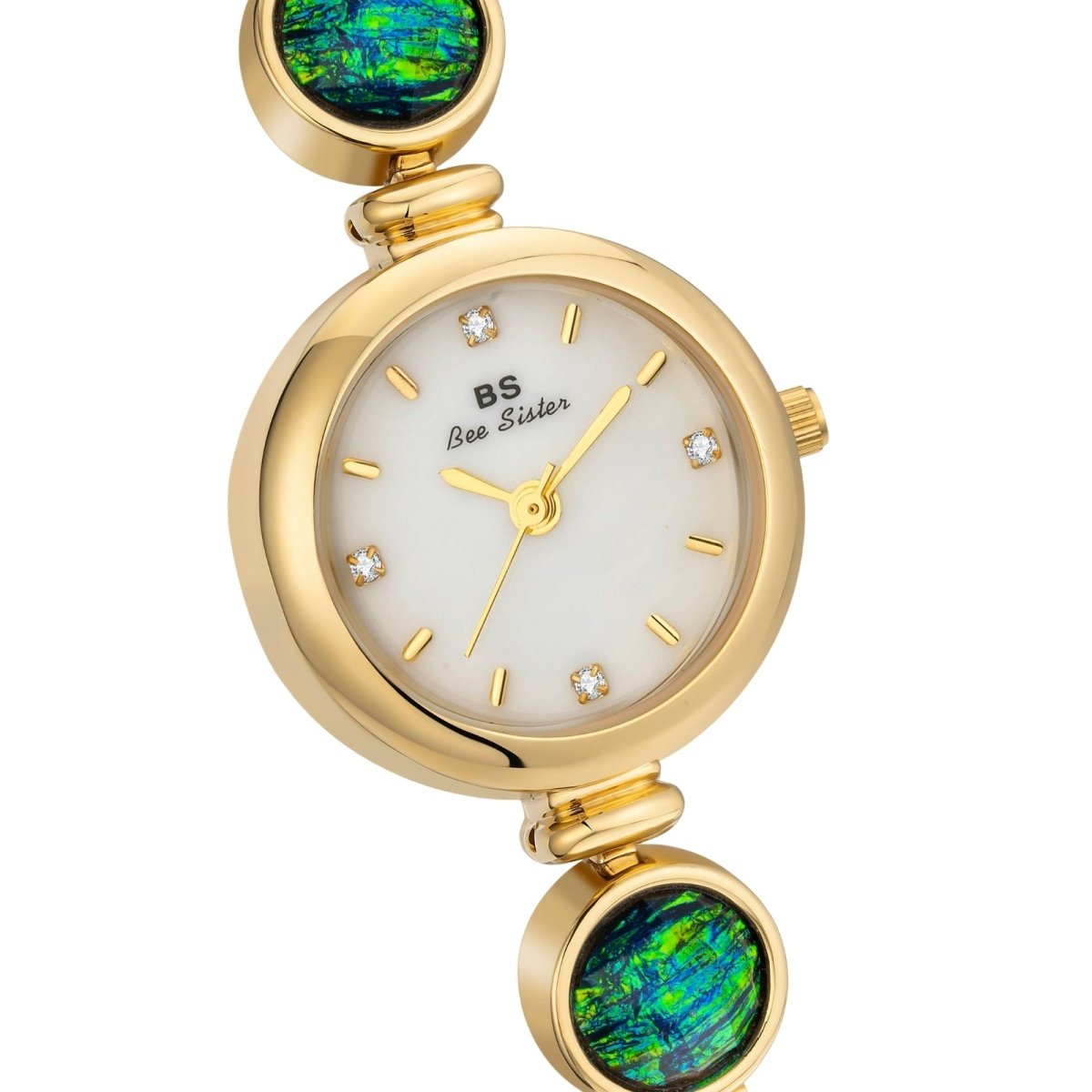 Gold kouvr watch with green gemstone accents on a white background
