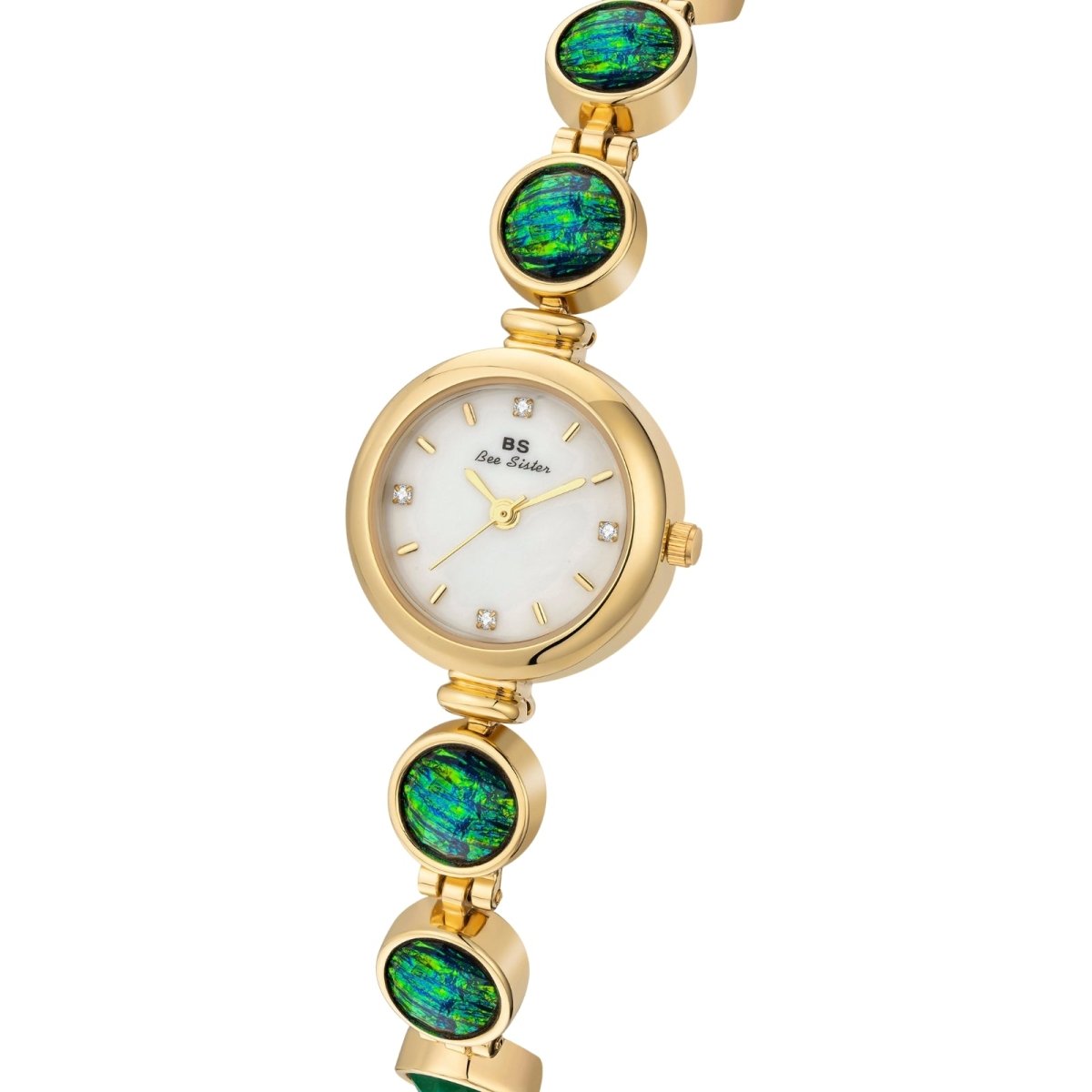 Gold kouvr watch with green gemstones on a white background