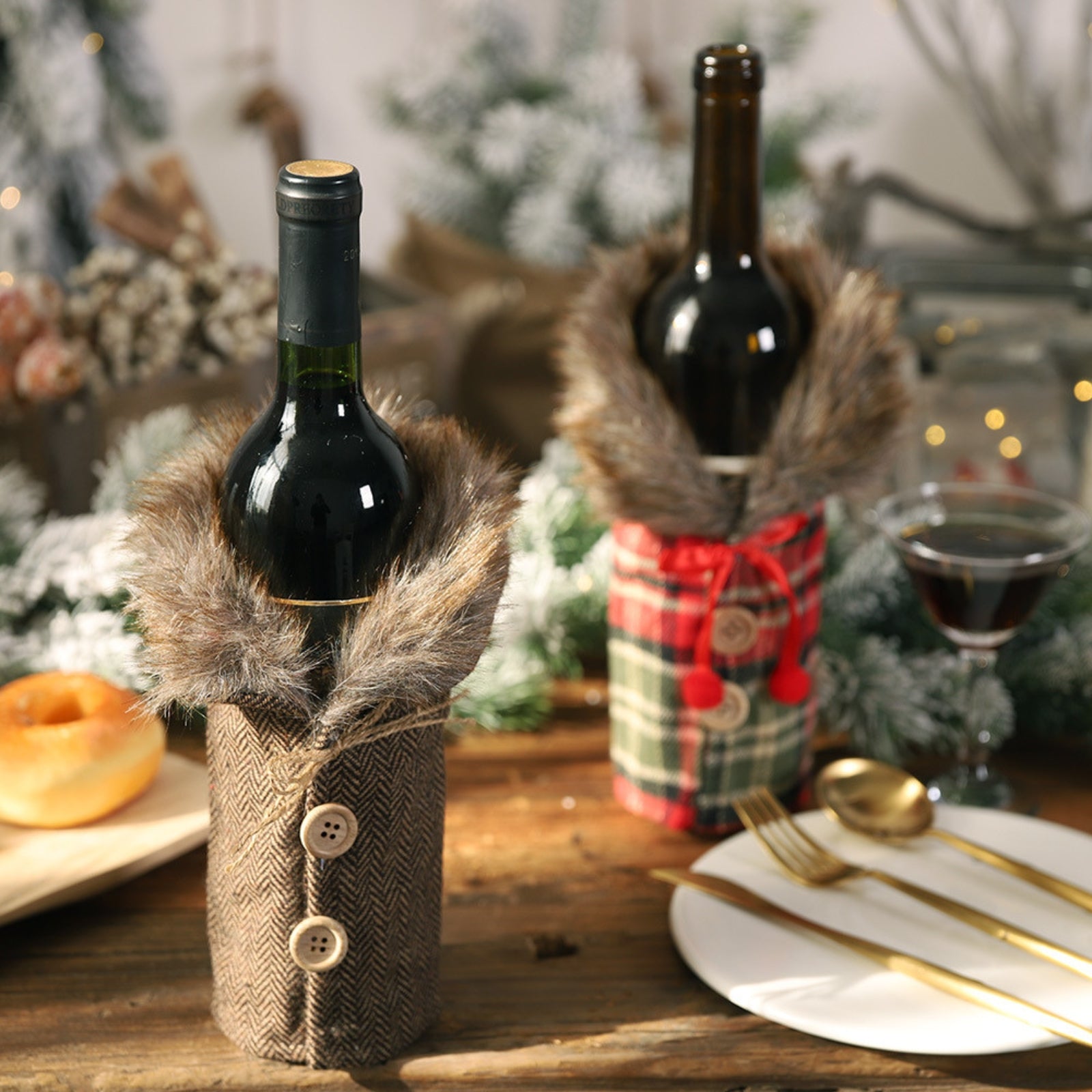 A festive holiday table setting featuring two wine bottles dressed in Kouvr's plaid and tweed faux fur coat covers, next to a place setting and wine glass.