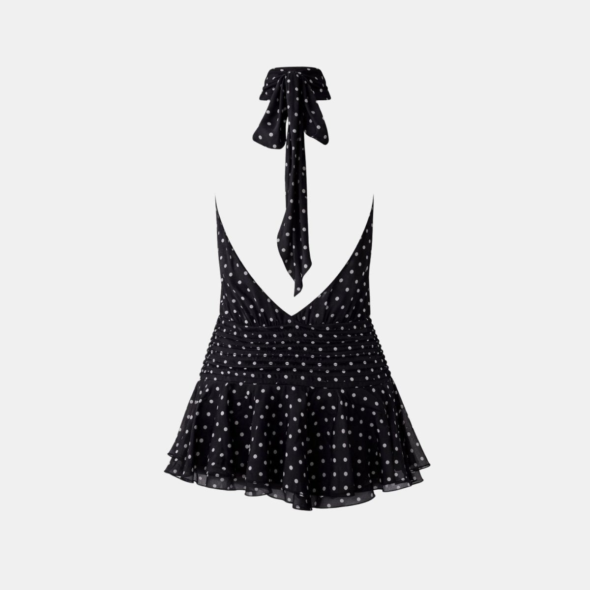 Flatlay image of the back of a black polka dot mini dress highlighting the open back and neck tie detail.