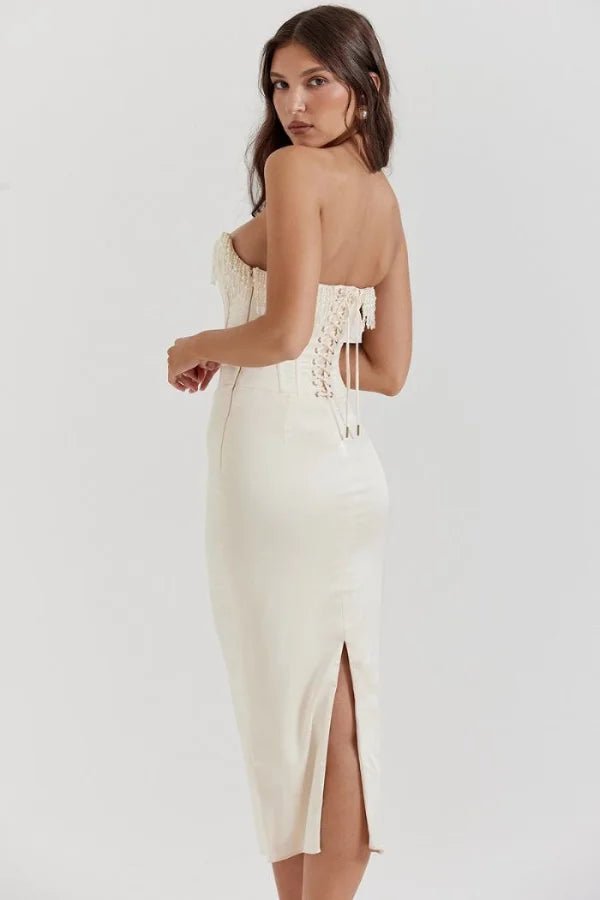 Model wearing Kouvr ivory satin strapless corset dress with pearl fringe