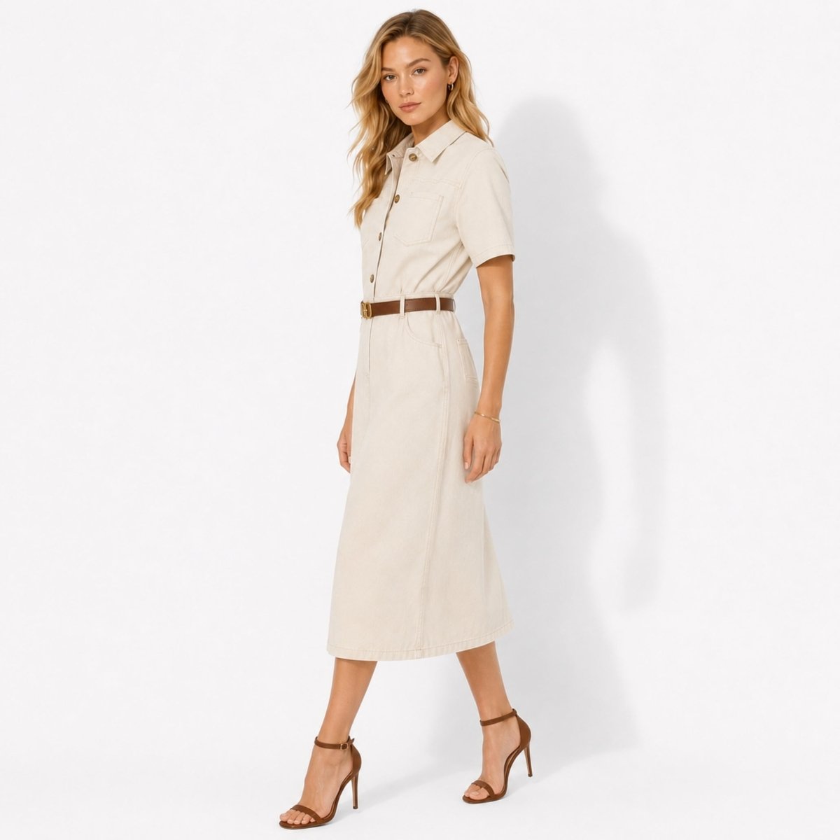 Side profile of woman in ivory belted button down midi dress showing tailored fit and short sleeves by Kouvr.