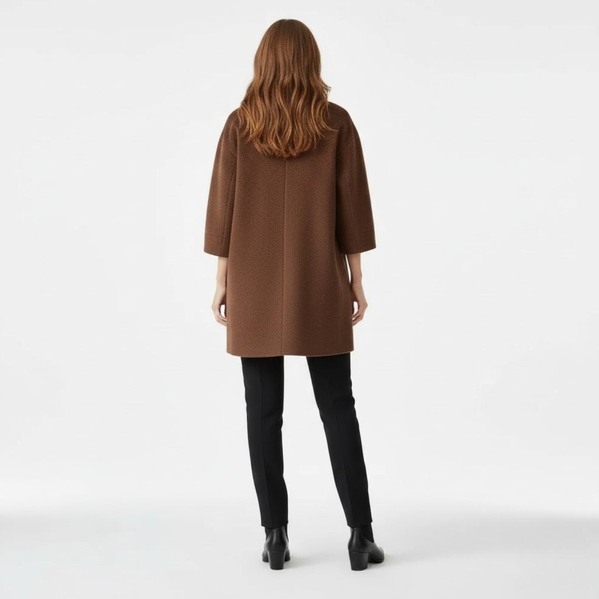 Back view of the Kouvr Janice wool-blend coat in brown, highlighting its clean lines and cocoon shape.