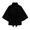 Model wearing the black Kouvr Jaye Cape Jacket, showcasing the tie-back belt and wide kimono sleeves