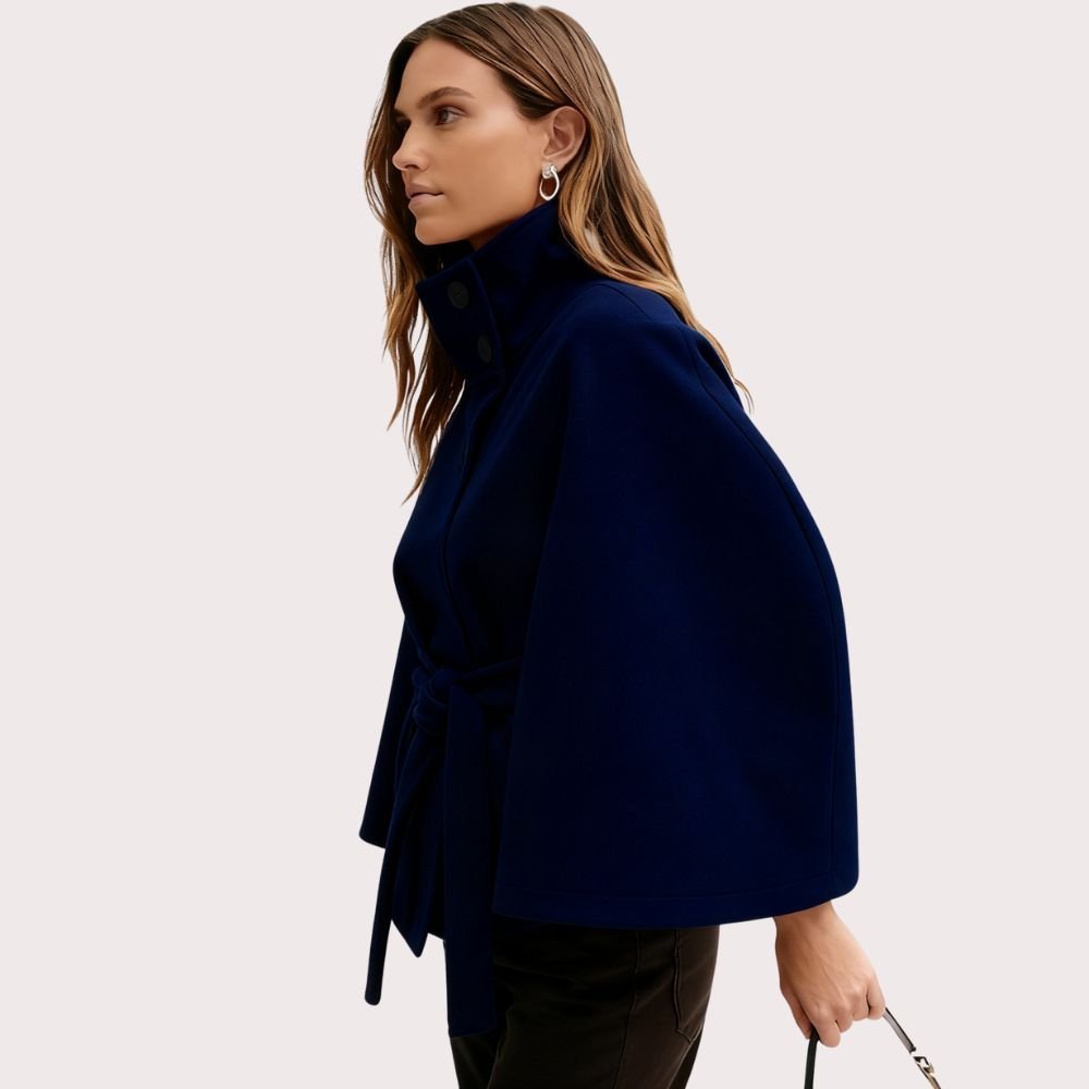 Model wearing Kouvr Fashion belted cape jacket with funnel neck and wide kimono sleeves
