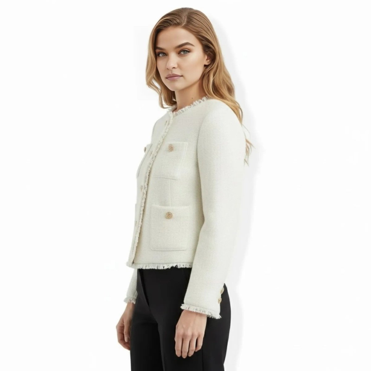 Side profile of a model wearing the Kouvr Jelani white collarless tweed jacket to show its fit and sleeve length.