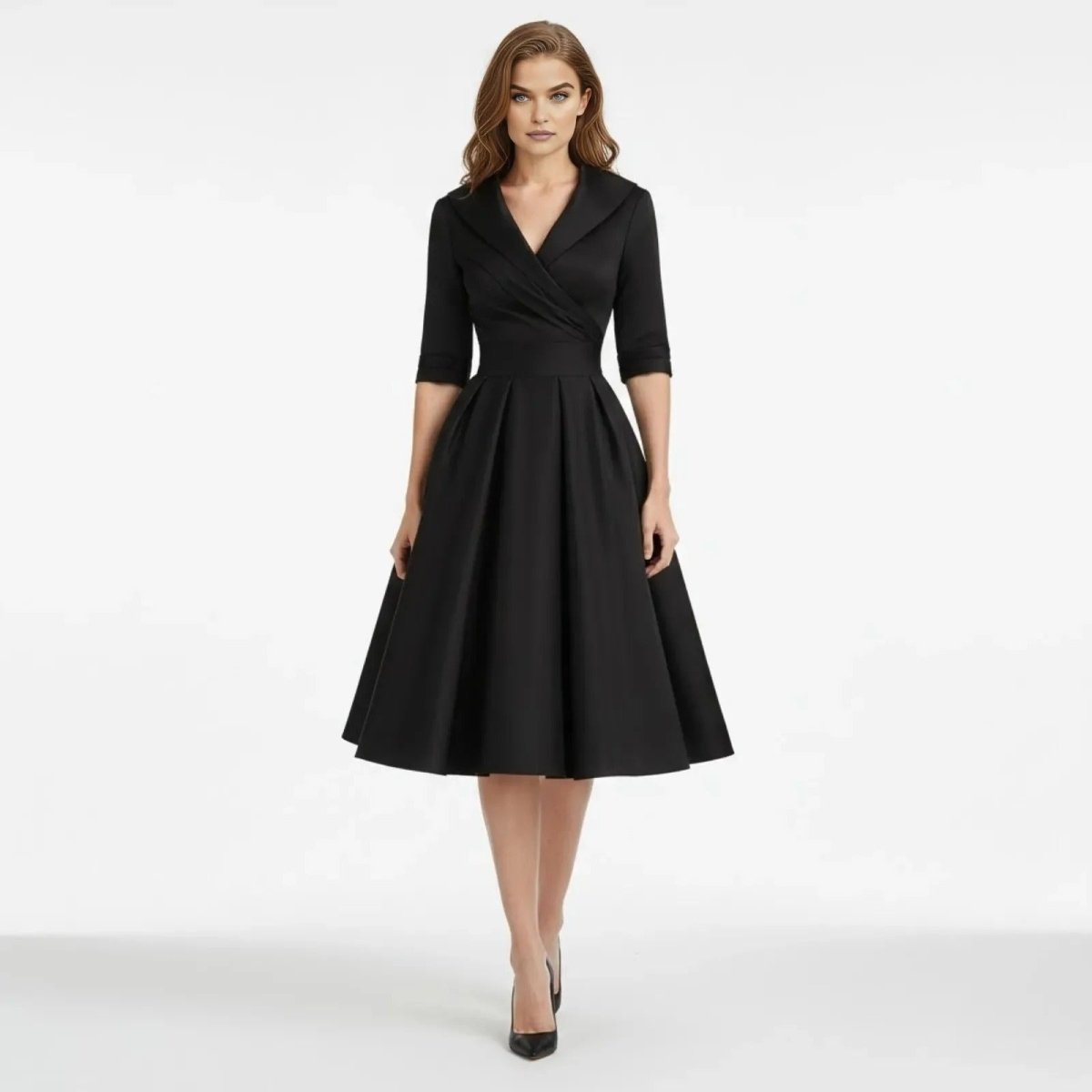 Model wearing the Kouvr Jenner black fit and flare midi dress with a classic lapel collar, shown from the front against a white background.