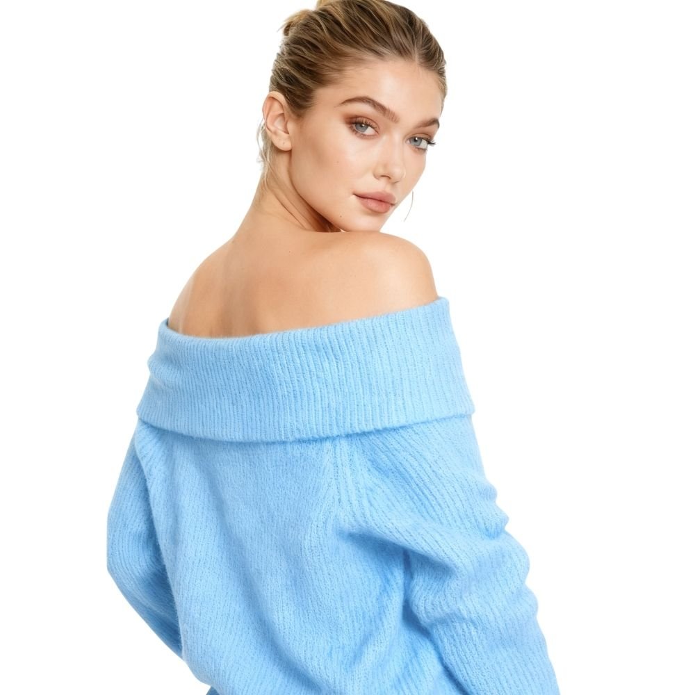 Woman wearing a light blue kouvr off-shoulder sweater on a white background