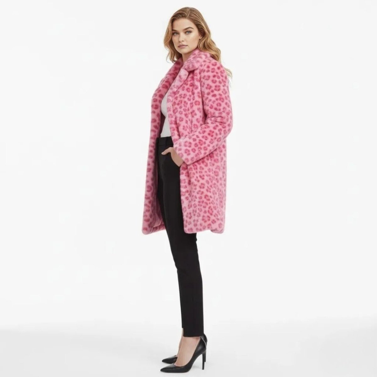 Model in a side profile view wearing the Kouvr Jovi longline pink leopard faux fur coat, showing its length and fit.