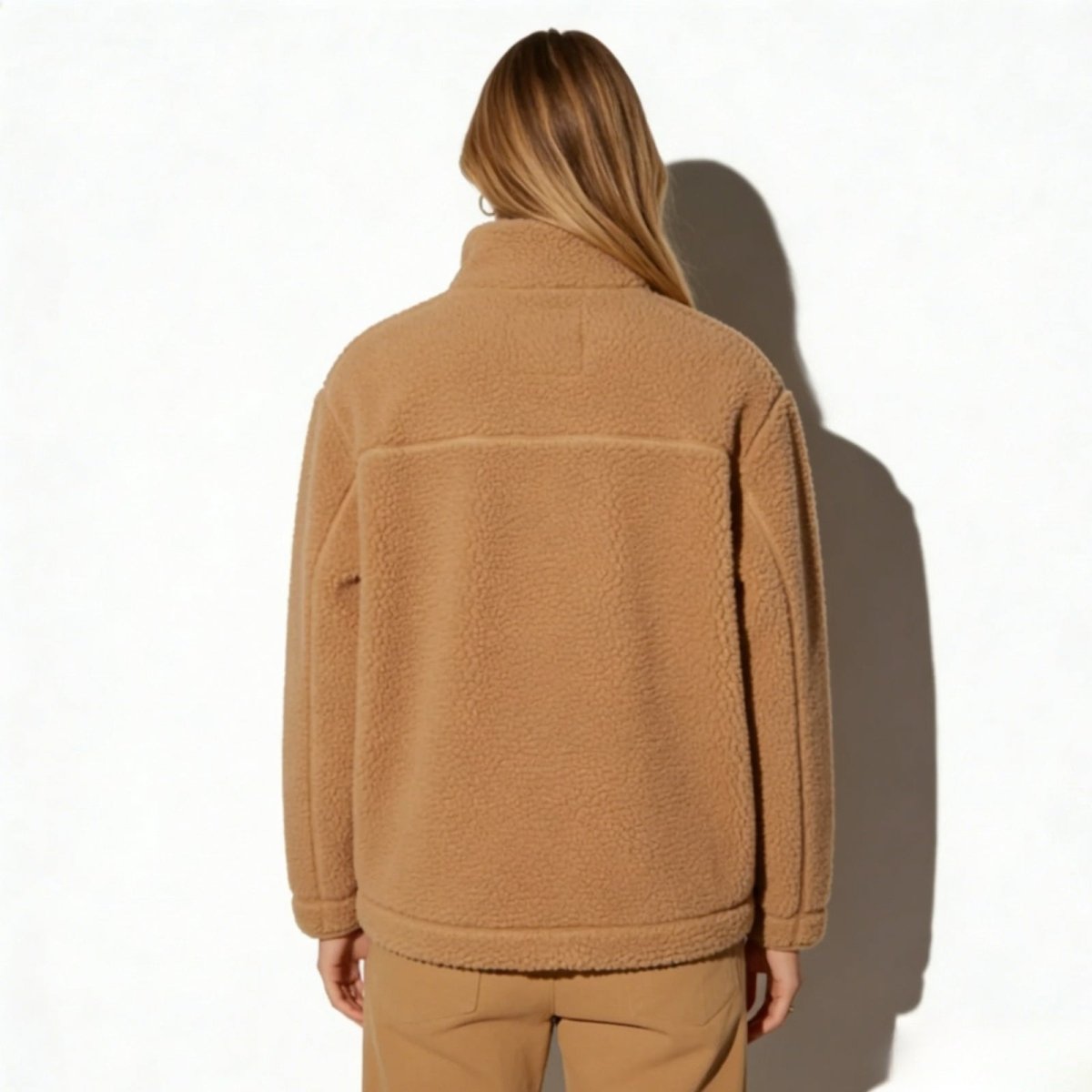 Back view of the Kouvr Julie fleece jacket in julie highlighting the horizontal back seam detail and overall silhouette.
