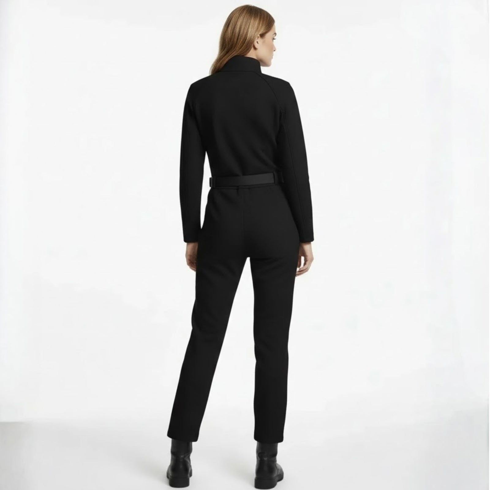Back view of the Kouvr Junnie black jumpsuit highlighting the belt detail and raglan sleeve construction.