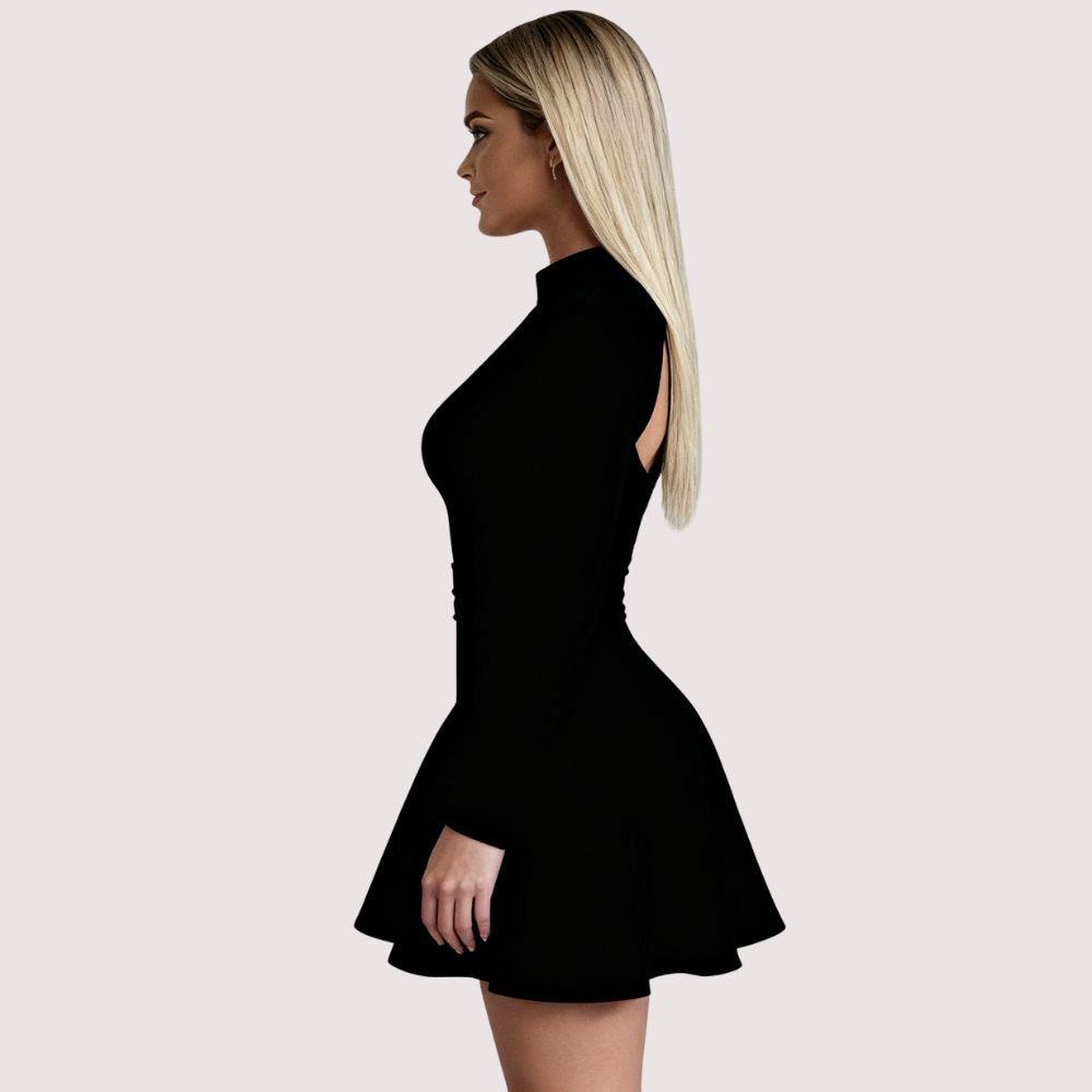 Woman wearing Kouvr Kaisha black long sleeve open-back mini dress in a stone archway