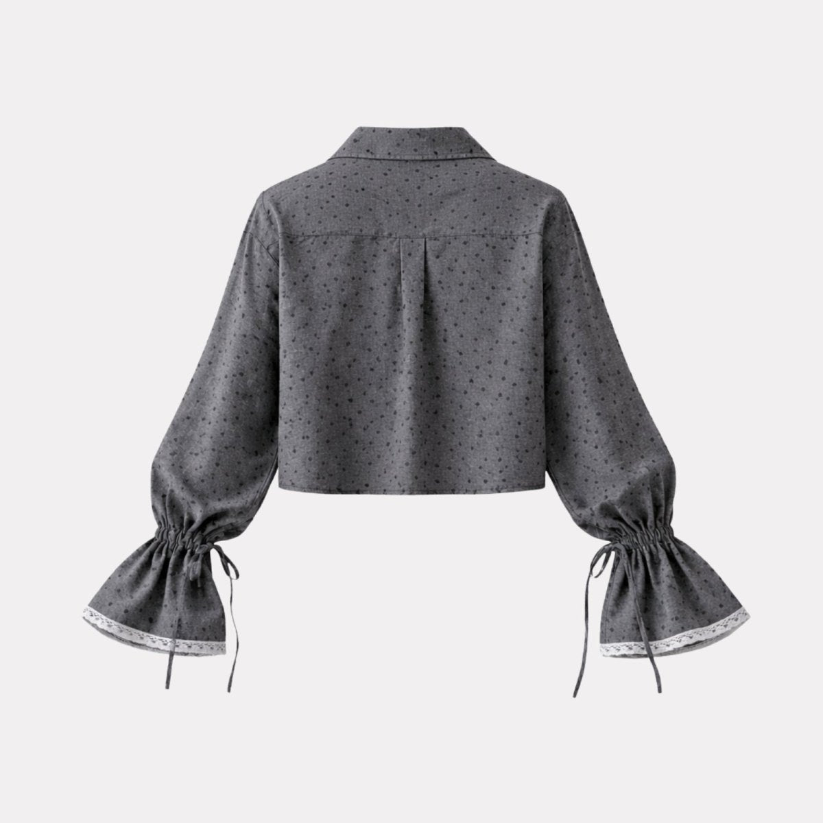 Flatlay of the back of the Kouvr Kara gray dotted blouse, displaying the collar and box pleat detail clearly.