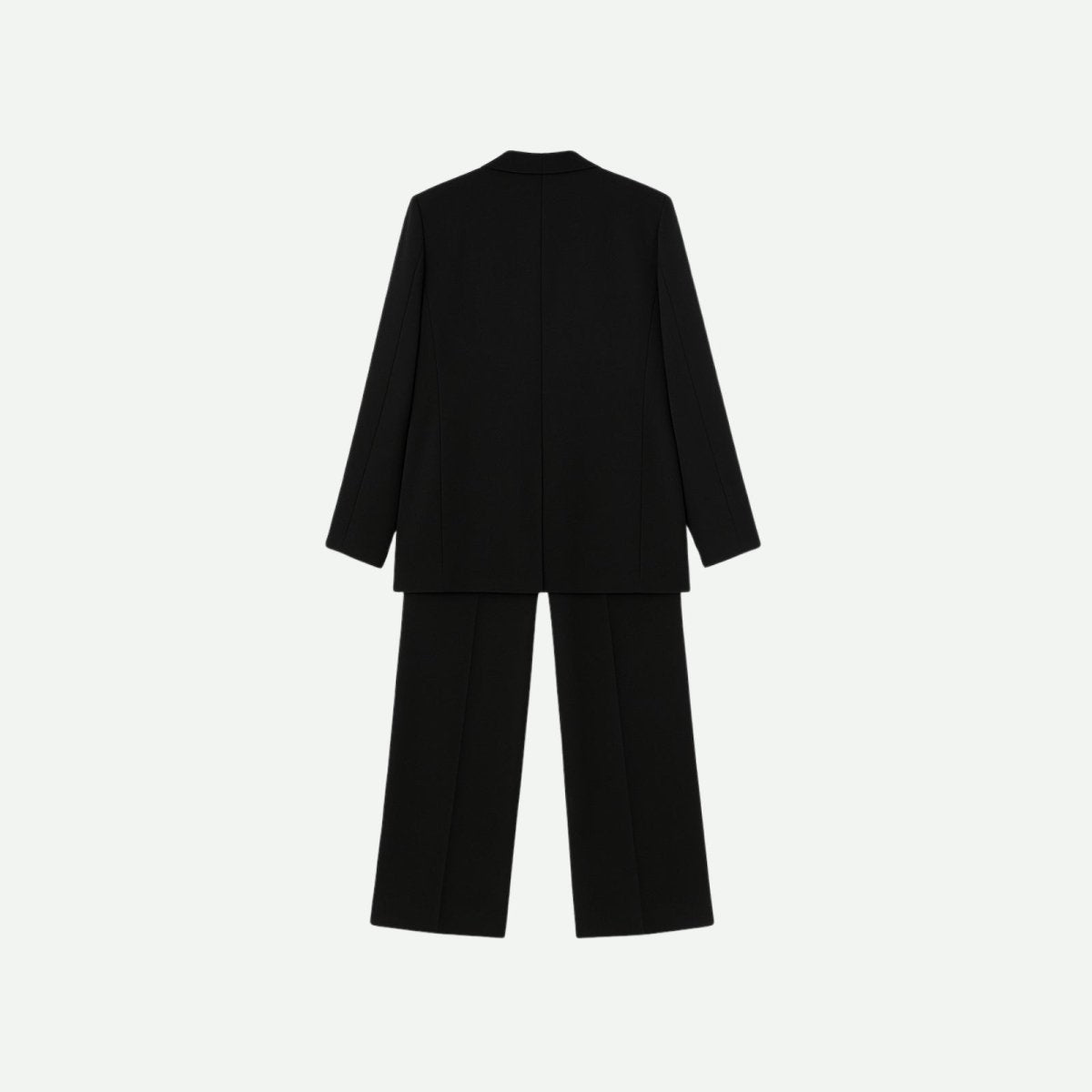 Flat lay showing the back of the Kouvr Fashion black blazer and trousers, detailing the construction and minimalist design.