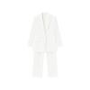 Flatlay of the Kouvr Kate white blazer and matching trousers, showing the sharp peak lapels, flap pockets, and pressed crease on the pants.