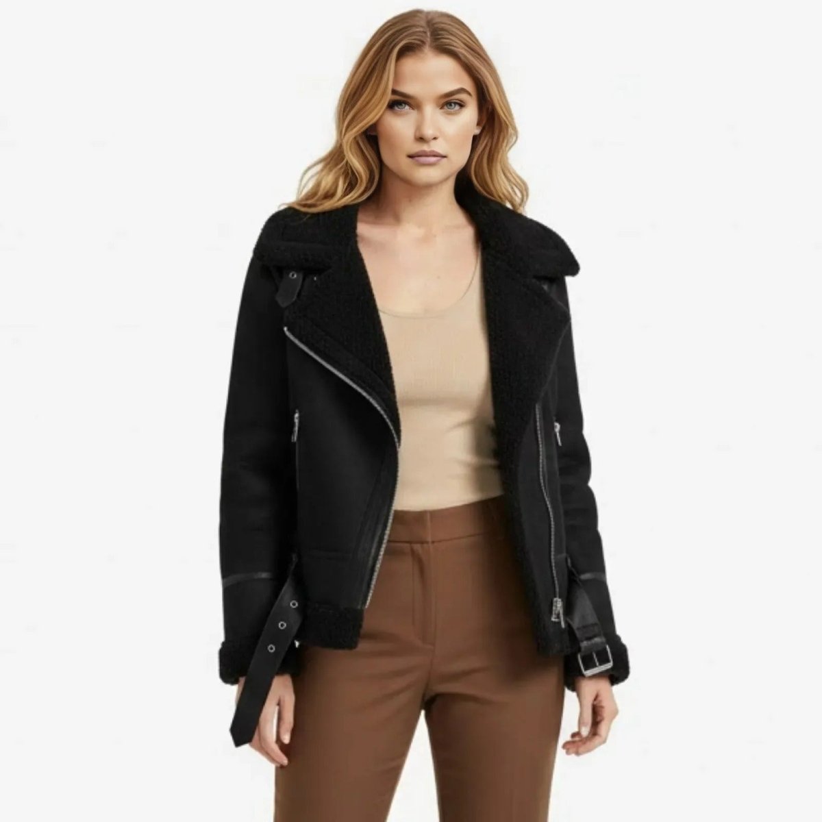 A woman facing forward wearing the Kouvr Katelynn black oversized shearling aviator jacket paired with brown trousers.