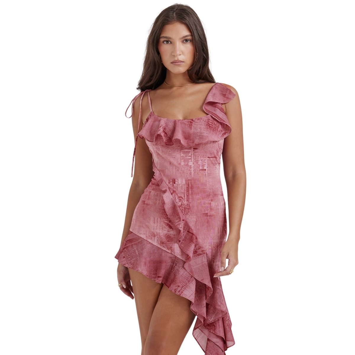 Woman wearing a pink print kouvr ruffled dress on a white background