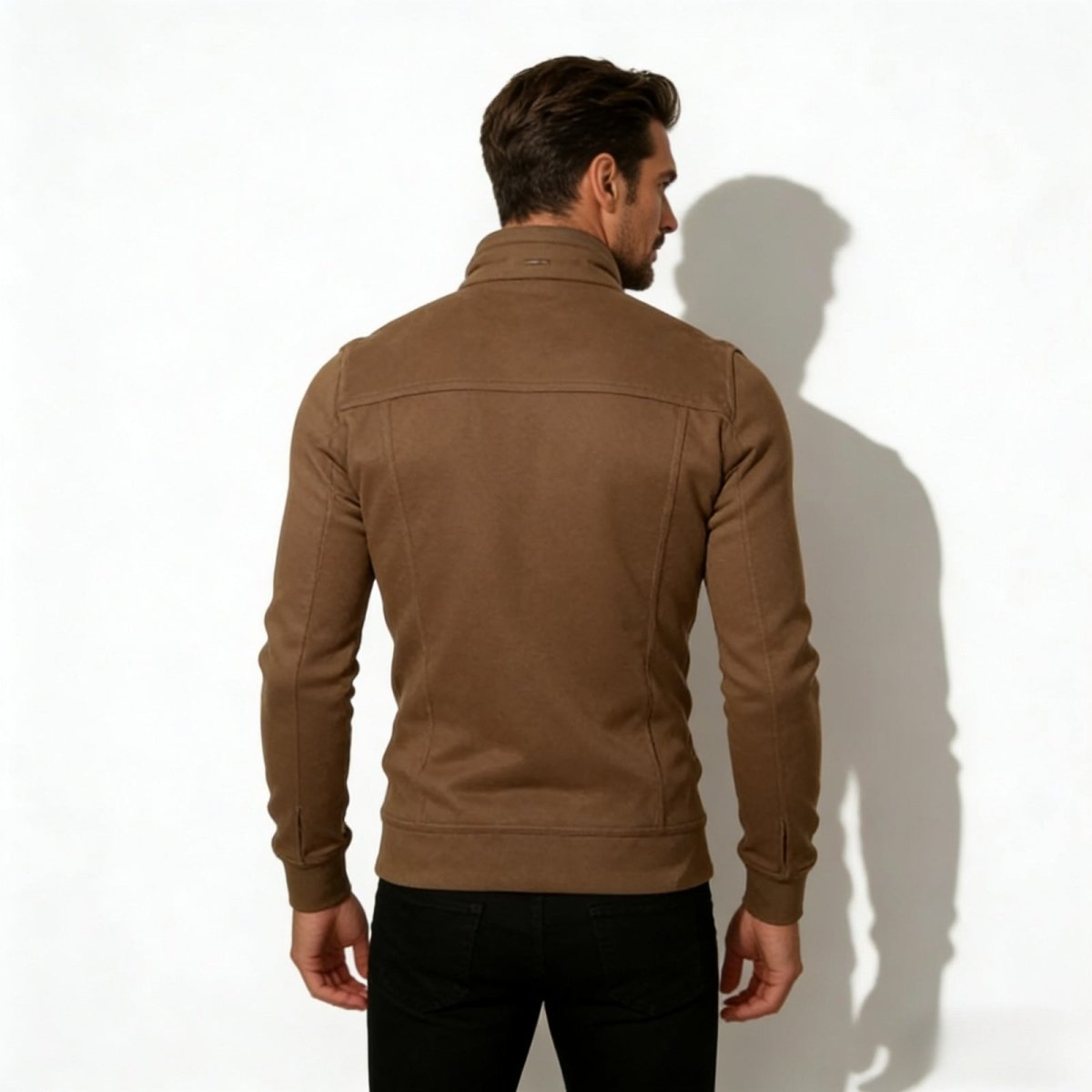 Back view of a male model in the Kouvr Kent brown jacket, highlighting the structured shoulder and back yoke detailing.