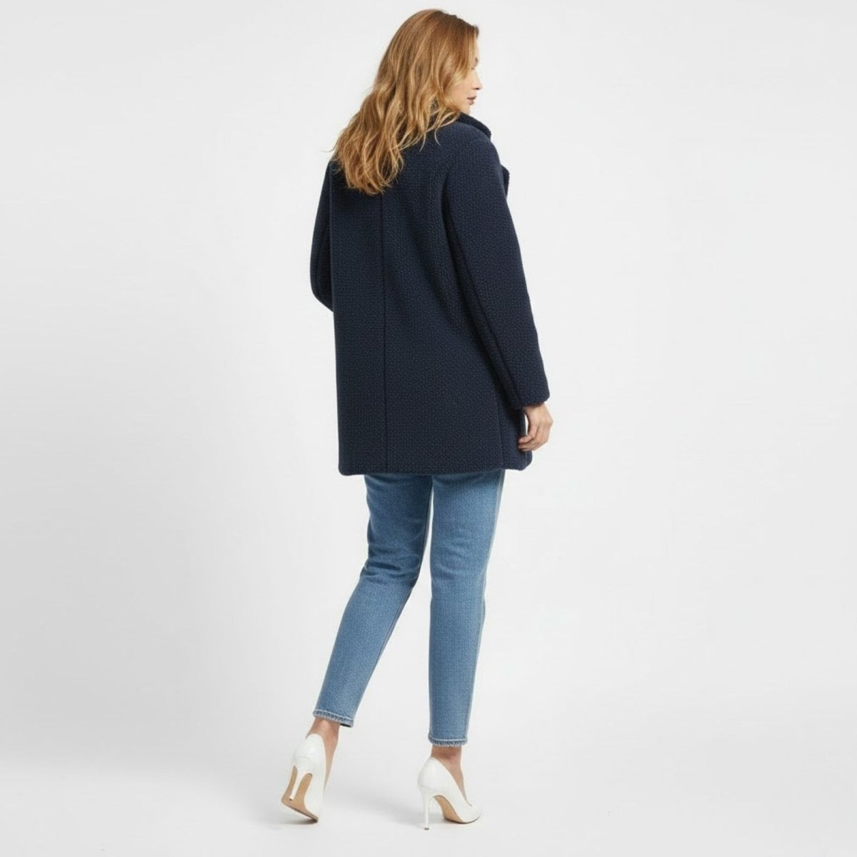 Back view of the Kouvr Kianna navy blue double-breasted teddy coat on a model, showcasing the clean seam work and shoulder structure.
