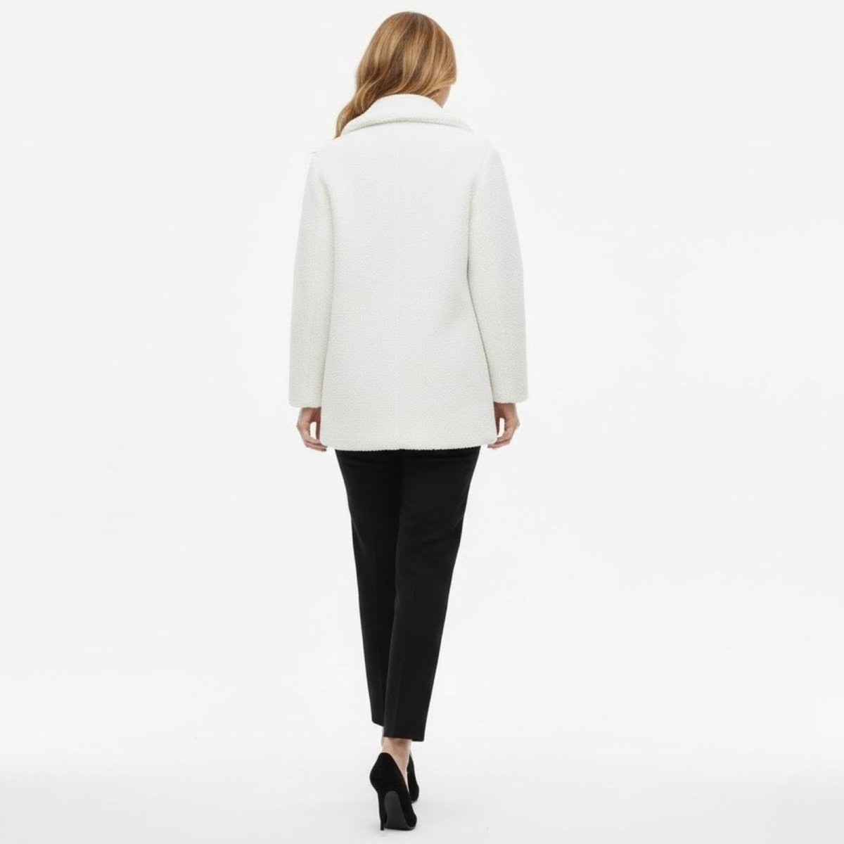 Back view of the Kouvr Kianna women's winter coat in ivory bouclé, highlighting its clean lines and expert tailoring.