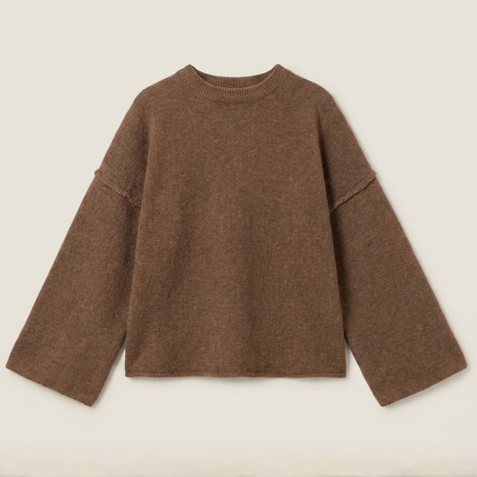 Flatlay product shot of the Kouvr Krystal bell sleeve sweater in brown, displaying the texture of the alpaca wool blend knit.