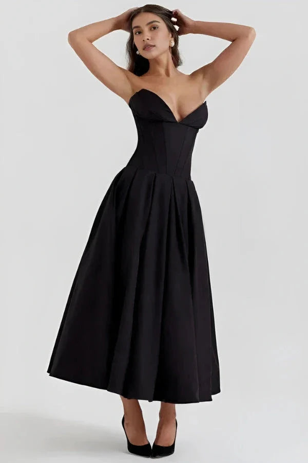 Model wearing Kouvr Fashion's black strapless corset midi dress for a formal event
