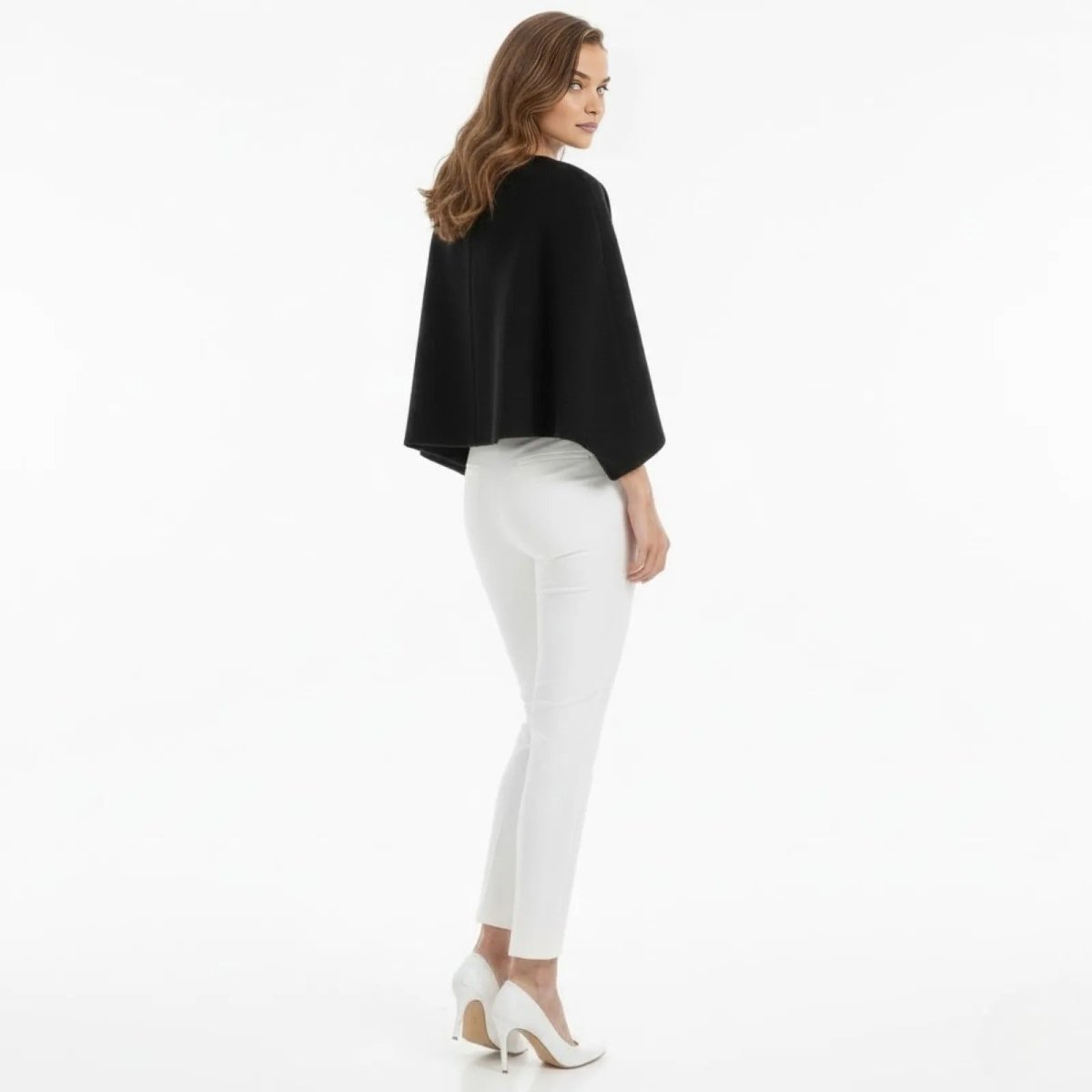 Back view of the Kouvr Laverne minimalist black cape jacket, highlighting its clean lines and structured shoulders.