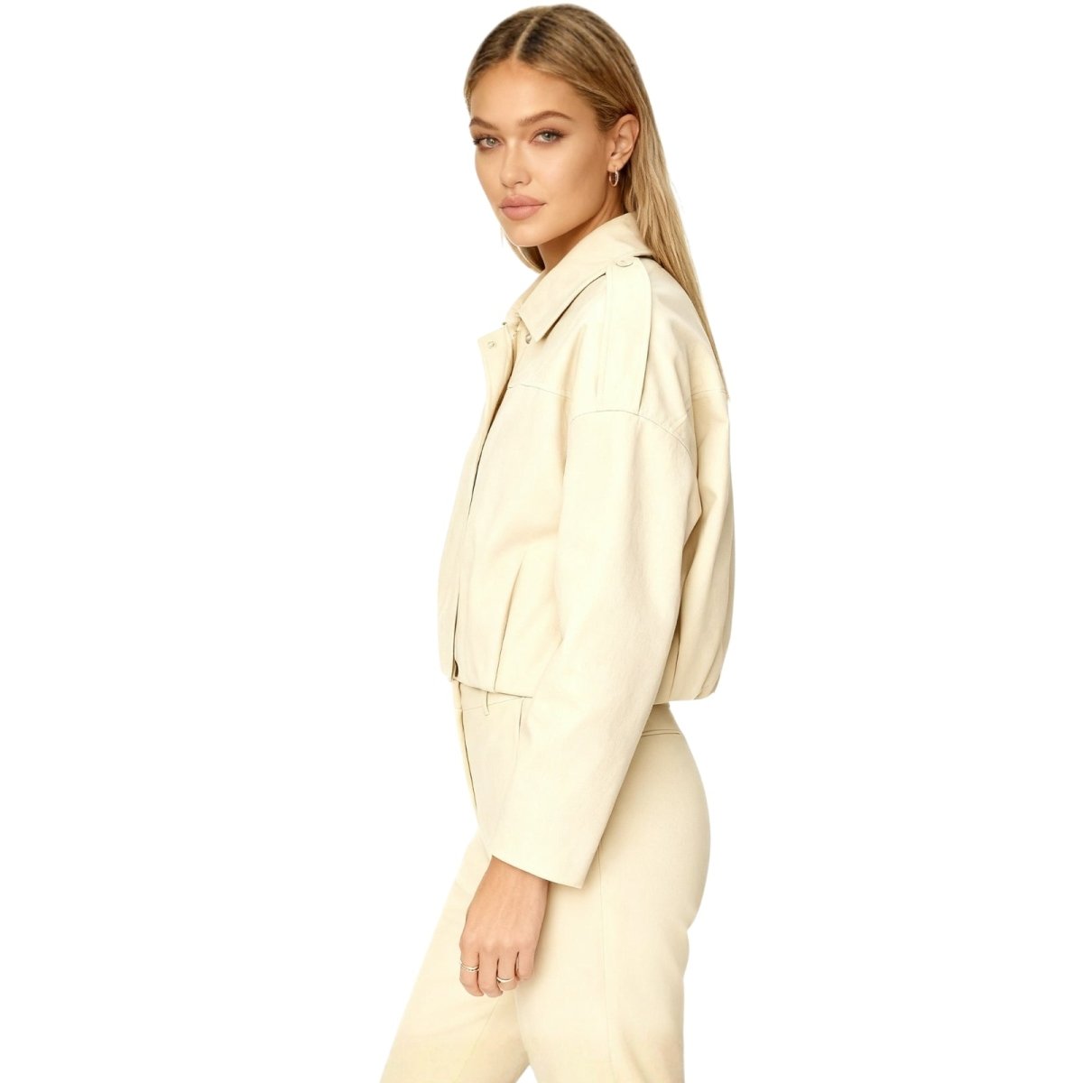 Woman wearing a beige Kouvr jacket suit on a white background
