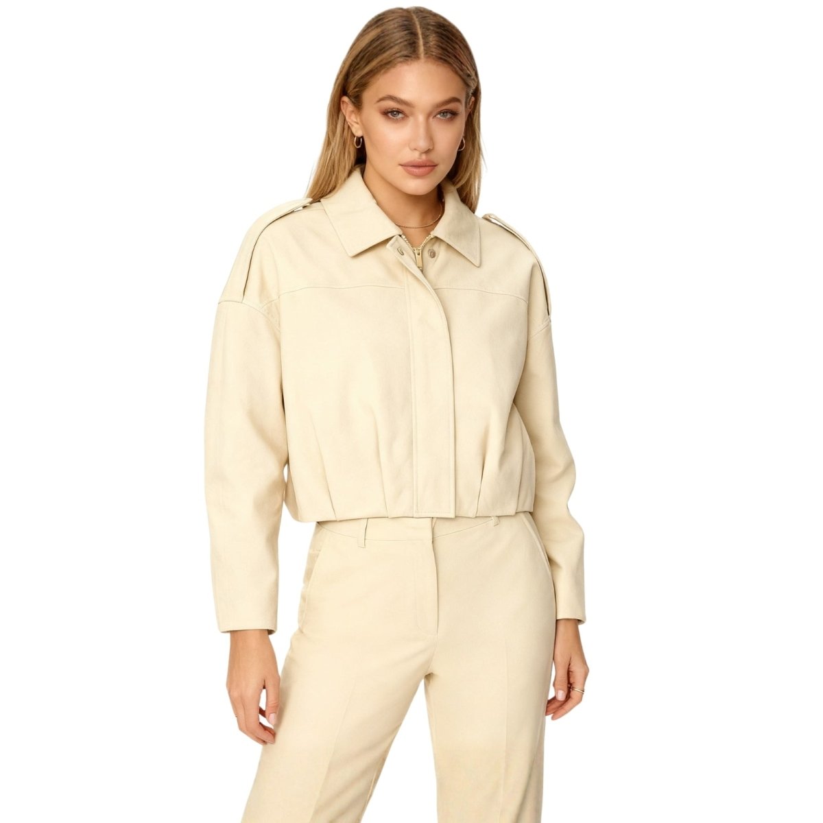 Woman wearing a beige Kouvr jacket on a white background